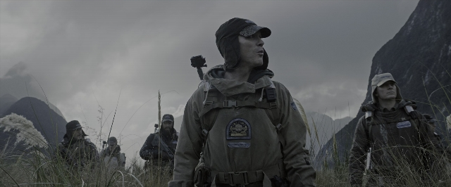 Wide shot frame from Alien: Covenant — standing, hat, uniform