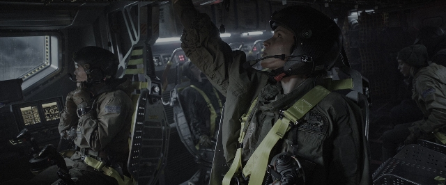 Wide shot frame from Alien: Covenant — sitting, standing, car
