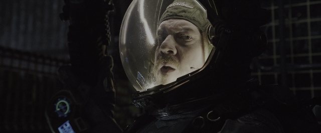 Wide shot frame from Alien: Covenant — hat, suit, mustache