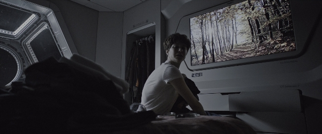 Wide shot frame from Alien: Covenant — sitting, door, street