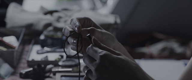 Wide shot frame from Alien: Covenant — table, hand, person