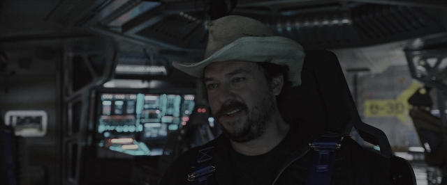 Wide shot frame from Alien: Covenant — sitting, hat, beard