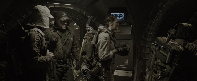 Wide shot frame from Alien: Covenant — standing, dialogue, hat