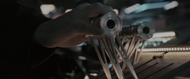 Frame from Alien: Covenant — room, hand, person