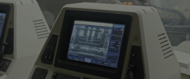 Wide shot frame from Alien: Romulus — sitting, table, computer monitor
