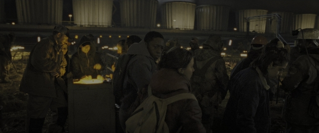 Wide shot frame from Alien: Romulus — dialogue, fire, night
