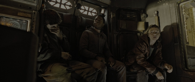 Wide shot frame from Alien: Romulus — sitting, door, car