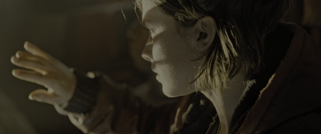 Wide shot frame from Alien: Romulus — face, hair, person
