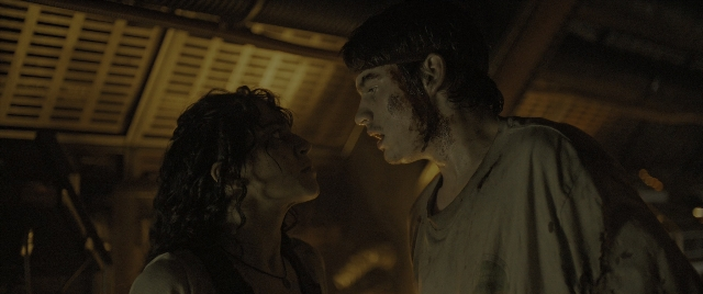Wide shot frame from Alien: Romulus — standing, room, face