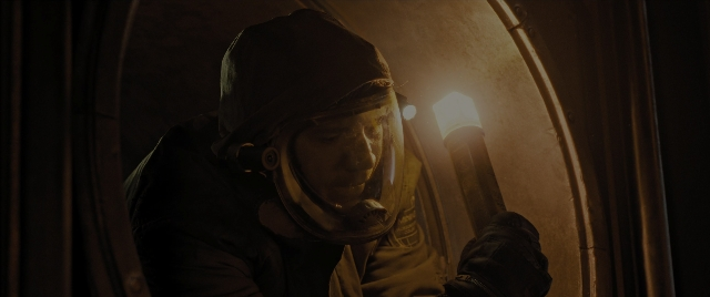 Wide shot frame from Alien: Romulus — hat, face, person
