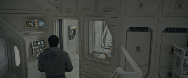 Wide shot frame from Alien: Romulus — standing, room, boat