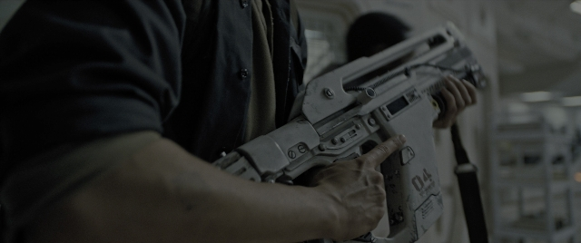 Frame from Alien: Romulus — room, shirt, gun