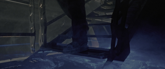 Wide shot frame from Alien: Romulus — standing, room, person