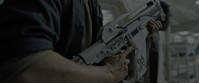 Wide shot frame from Alien: Romulus — room, hand, shirt