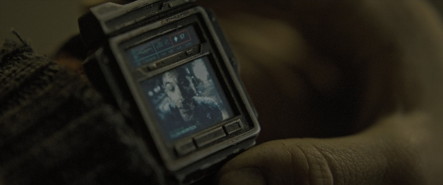 Wide shot frame from Alien: Romulus — room, phone, hand