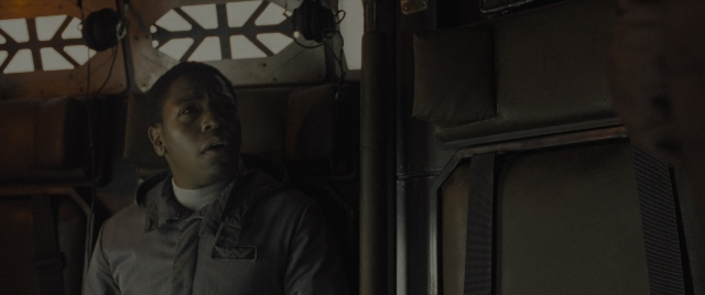 Wide shot frame from Alien: Romulus — sitting, door, car