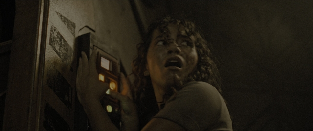 Medium shot frame from Alien: Romulus — room, hand, face