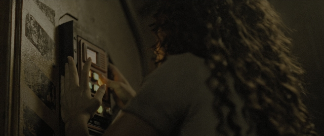 Medium shot frame from Alien: Romulus — standing, hand, face