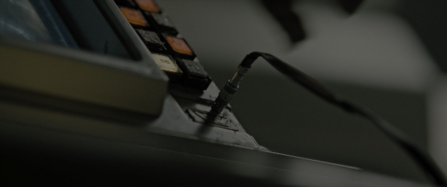 Frame from Alien: Romulus — table, microphone