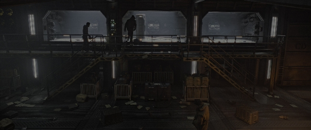Wide shot frame from Alien: Romulus — standing, room, person