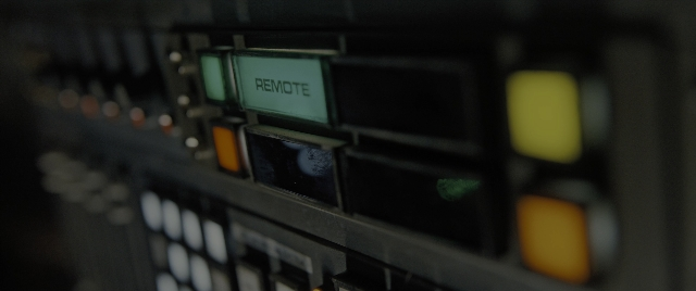 Wide shot frame from Alien: Romulus — room, window, land vehicle