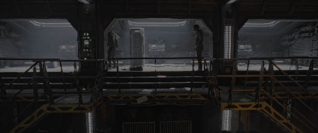 Wide shot frame from Alien: Romulus — standing, room, person