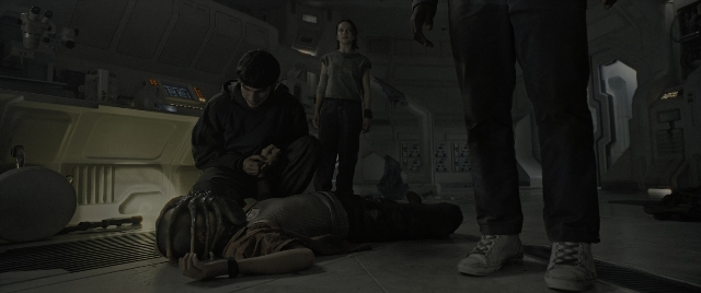 Wide shot frame from Alien: Romulus — standing, hand, gun