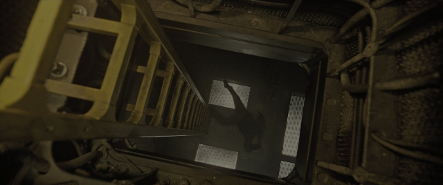 Wide shot frame from Alien: Romulus — standing, room, person