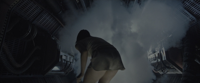 Wide shot frame from Alien: Romulus — standing, smoke, person