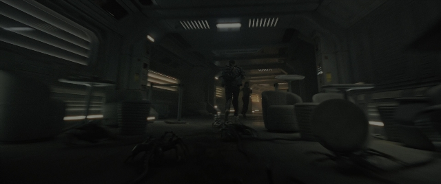 Wide shot frame from Alien: Romulus — standing, room, hat