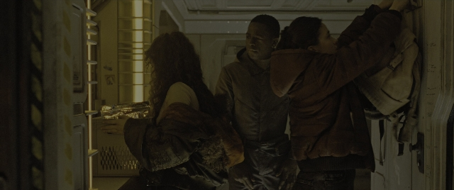Wide shot frame from Alien: Romulus — standing, night, hair