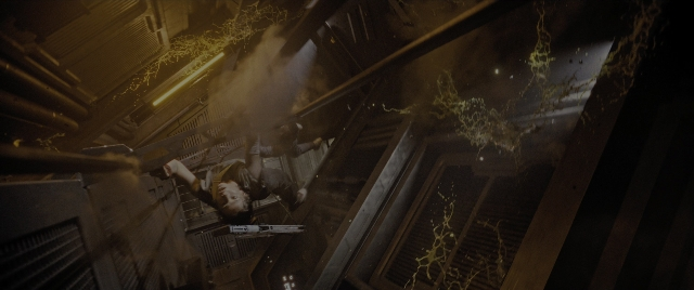 Wide shot frame from Alien: Romulus — room, hand, gun