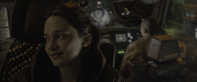 Medium shot frame from Alien: Romulus — sitting, room, face