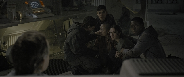 Wide shot frame from Alien: Romulus — sitting, standing, room