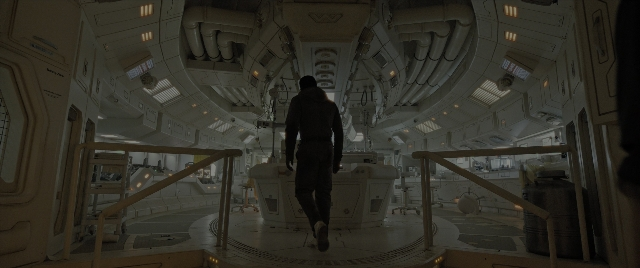 Wide shot frame from Alien: Romulus — walking, suit, person