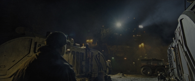 Wide shot frame from Alien: Romulus — standing, door, hat