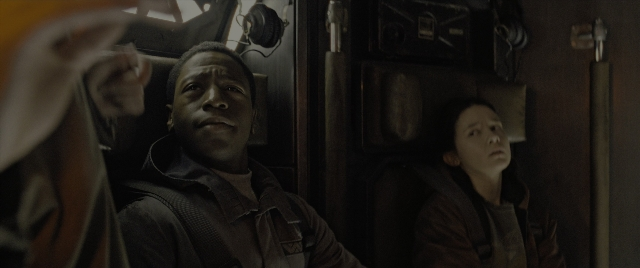 Medium shot frame from Alien: Romulus — sitting, car, face