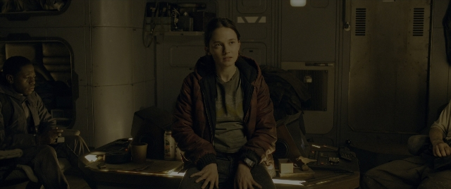 Wide shot frame from Alien: Romulus — sitting, room, table
