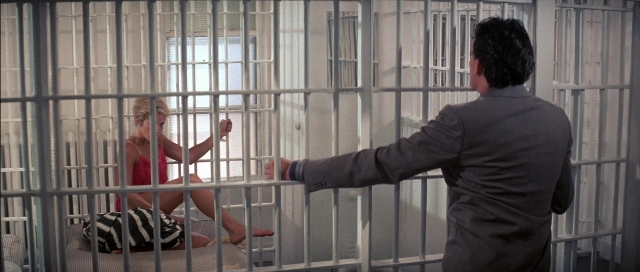 Frame from The Adventures of Buckaroo Banzai Across the 8th Dimension — sitting, standing, bed