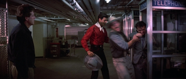 Wide shot frame from The Adventures of Buckaroo Banzai Across the 8th Dimension — standing, plate, room
