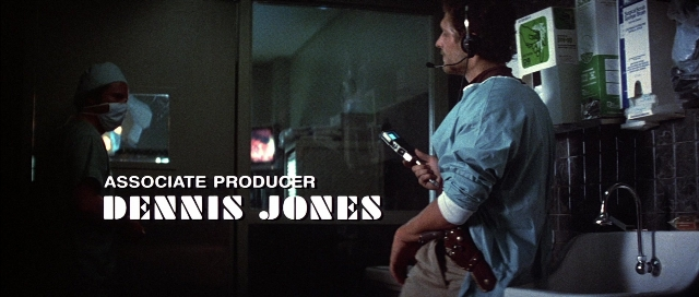 Frame from The Adventures of Buckaroo Banzai Across the 8th Dimension — standing, dialogue, mirror