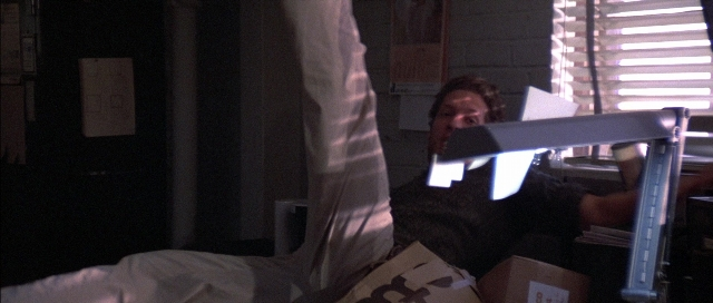 Wide shot frame from The Adventures of Buckaroo Banzai Across the 8th Dimension — room, bed, shirt