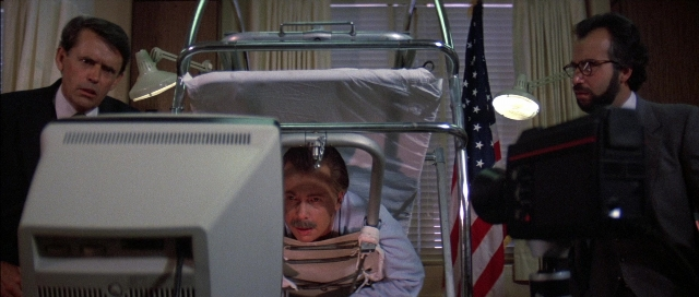 Wide shot frame from The Adventures of Buckaroo Banzai Across the 8th Dimension — standing, bed, person