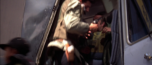 Wide shot frame from The Adventures of Buckaroo Banzai Across the 8th Dimension — dialogue, door, car
