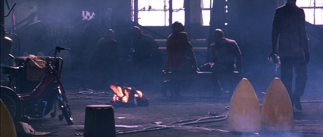 Wide shot frame from The Adventures of Buckaroo Banzai Across the 8th Dimension — sitting, room, dialogue