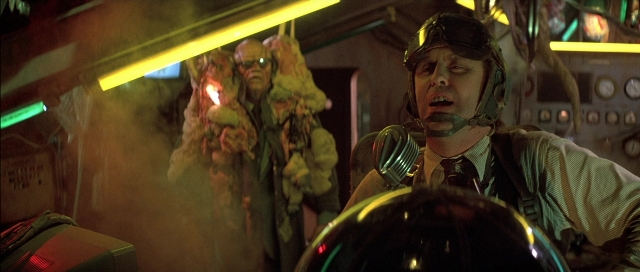 Wide shot frame from The Adventures of Buckaroo Banzai Across the 8th Dimension — sitting, dialogue, hat