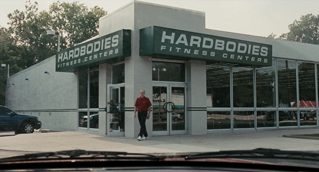 Wide shot frame from Burn After Reading — walking, car, shirt