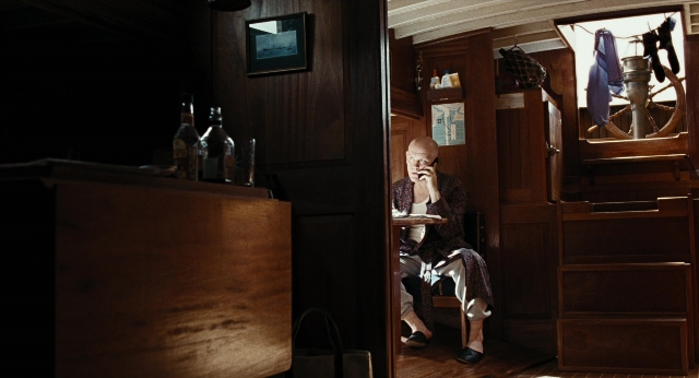 Wide shot frame from Burn After Reading — sitting, room, table