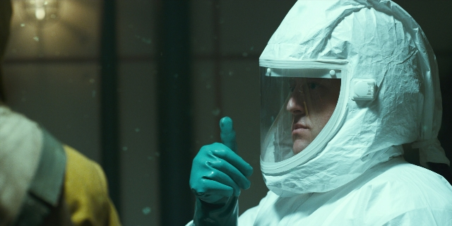 Wide shot frame from Stranger Things — hat, suit, face