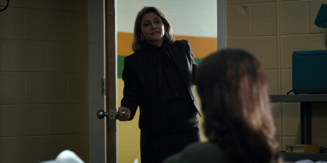 Wide shot frame from Stranger Things — sitting, standing, room